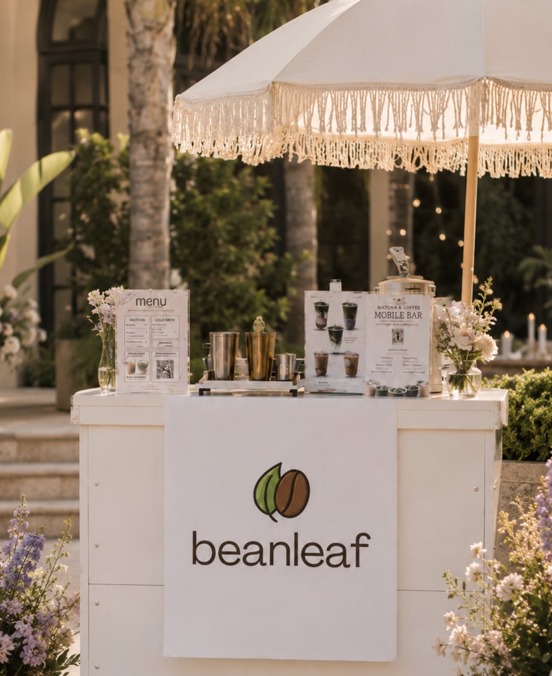 Beanleaf cart under a fringed umbrella surrounded by flowers
