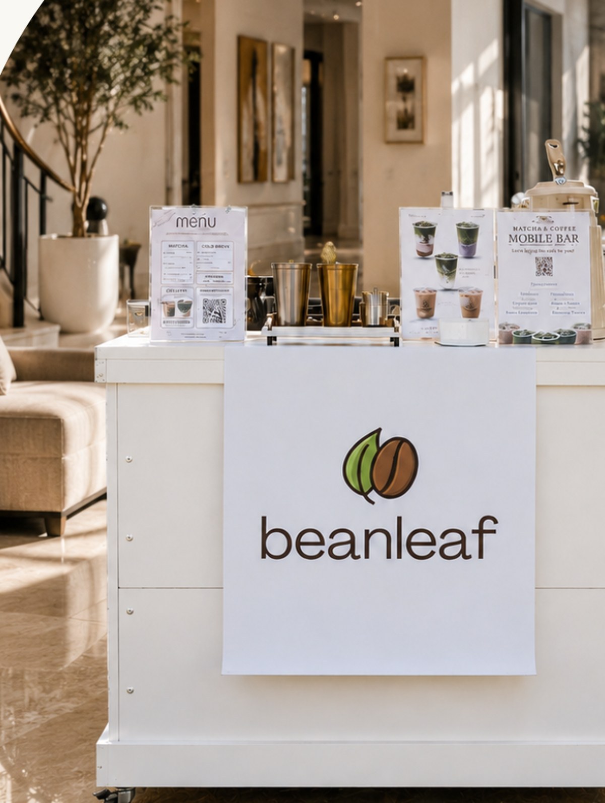 The Beanleaf mobile bar set up inside a bright marble lobby, styled with menu cards and brass tools.