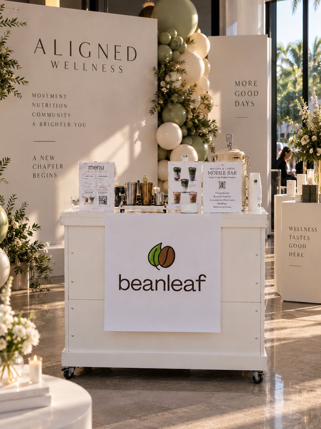 Beanleaf bar styled for an Aligned Wellness event with custom signage, sage balloons and florals